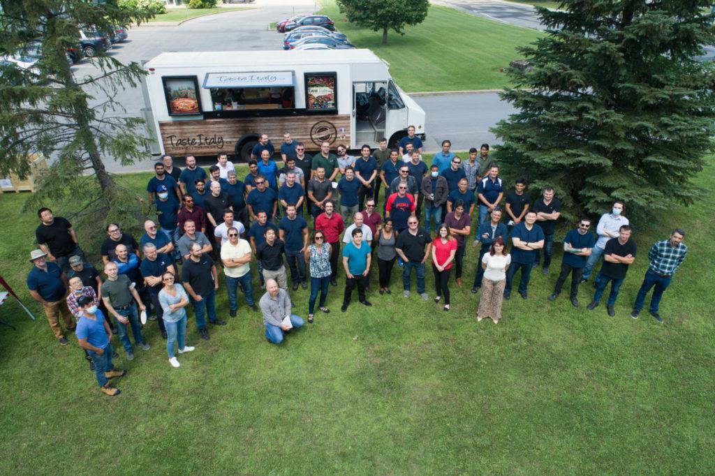 Group photo of BellatRx employees standing on a lawn
